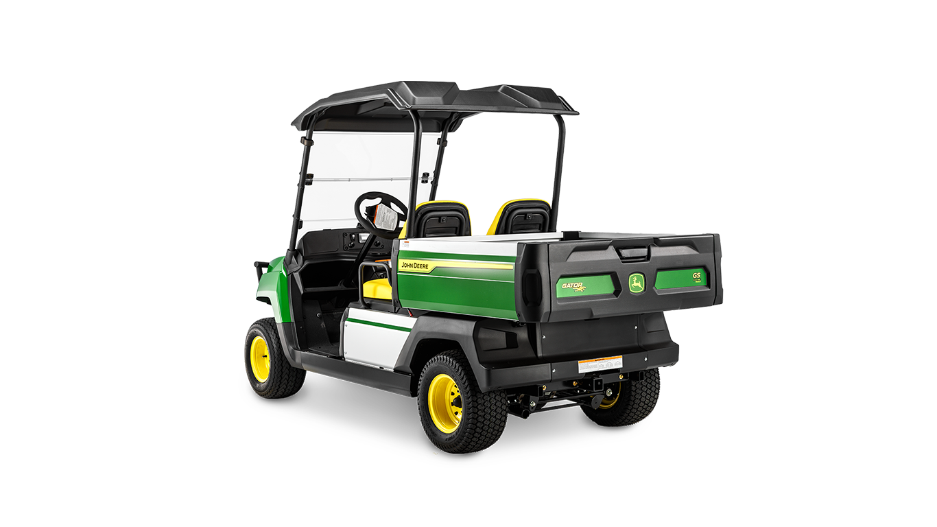 "John Deere Gator GS" benzininio modelio kampinis vaizdas iš galo su krovinių platforma, dvigubomis sėdynėmis ir apsauginiu stogu.